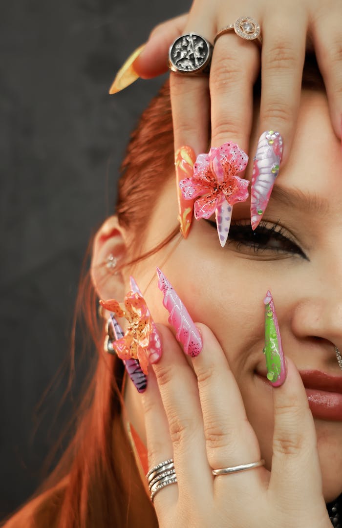 Vibrant and intricate nail art on a woman's hands, showcasing creativity and style.